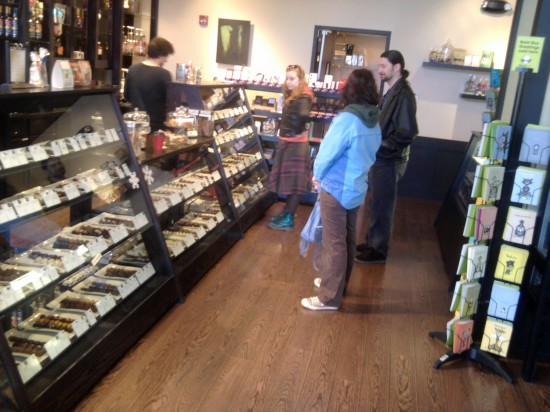 Chocoholique My husband, sister and niece standing at a chocolate store counter.